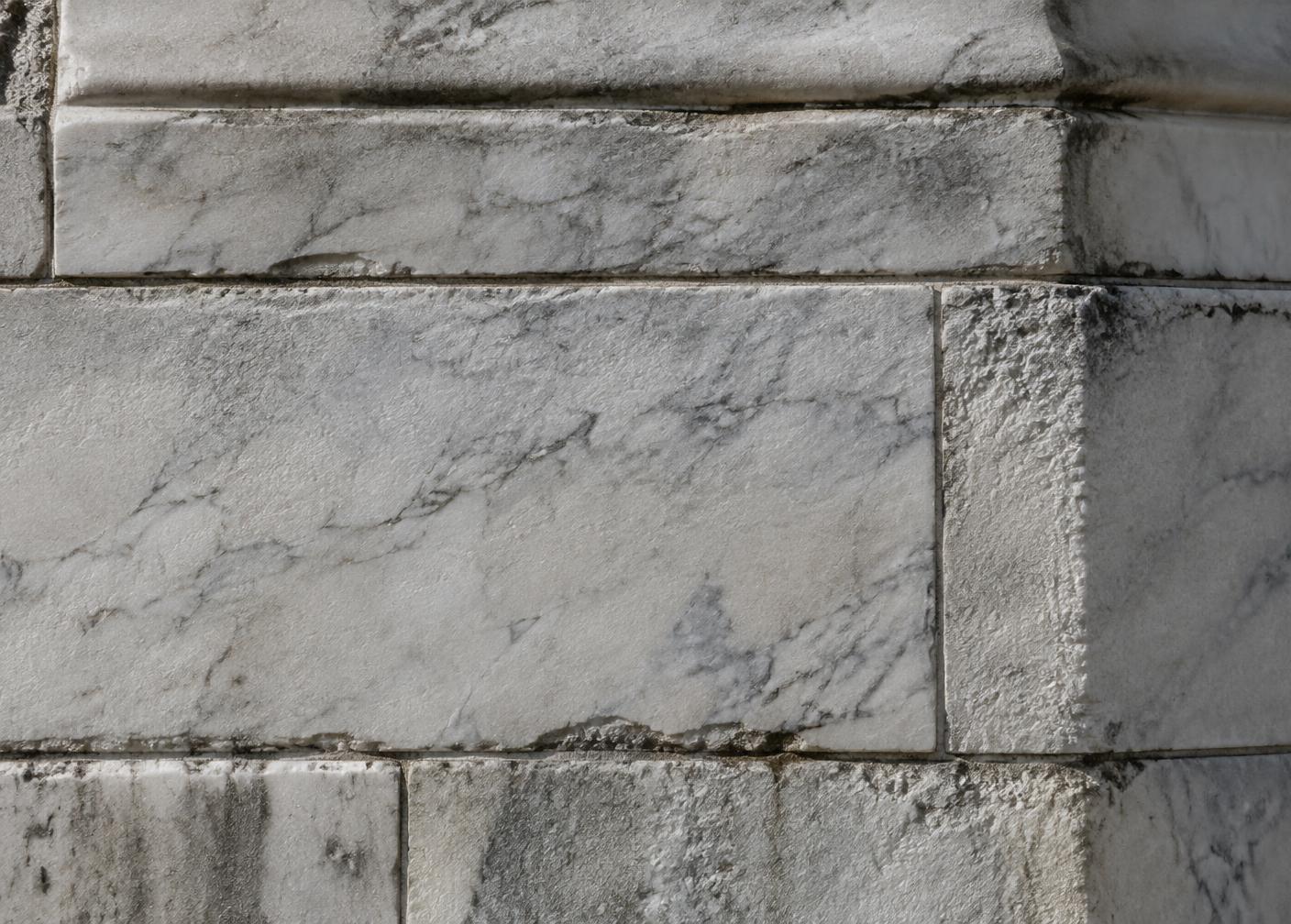 Close view of weathered marble ashlar and mortar joints